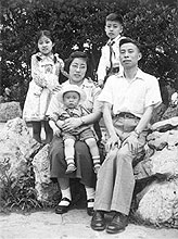 Wenda Gu in his mother's lap with his father, sister, and brother. 1958